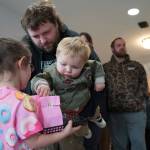 Children distribute bags of doughnut holes during a ribbon-cutting event for The Glaze in Kenai, Alaska, on Wednesday, Sept. 4, 2024. (Jake Dye/Peninsula Clarion)