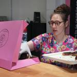 Jake Dye/Peninsula Clarion
Abi Gutierrez fills a box of donuts during a ribbon cutting event for The Glaze in Kenai on Wednesday, Sept. 4.