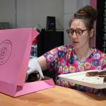 Abi Gutierrez fills a box of doughnuts during a ribbon-cutting event for The Glaze in Kenai, Alaska, on Wednesday, Sept. 4, 2024. (Jake Dye/Peninsula Clarion)