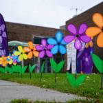 Promise flowers line a pathway at the Second Annual Kenai Peninsula Walk to End Alzheimers at the Challenger Learning Center of Alaska in Kenai, Alaska, on Saturday, Sept. 7, 2024. (Jake Dye/Peninsula Clarion)