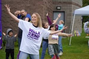 Diamond Dance Project performs alongside people pulled from their audience ahead of the start of the Second Annual Kenai Peninsula Walk to End Alzheimers at the Challenger Learning Center of Alaska in Kenai, Alaska, on Saturday, Sept. 7, 2024. (Jake Dye/Peninsula Clarion)