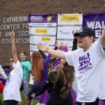 Diamond Dance Project performs alongside people pulled from their audience ahead of the start of the Second Annual Kenai Peninsula Walk to End Alzheimers at the Challenger Learning Center of Alaska in Kenai, Alaska, on Saturday, Sept. 7, 2024. (Jake Dye/Peninsula Clarion)