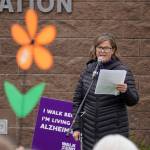 Promise flowers are held aloft during a ceremony ahead of the start of the Second Annual Kenai Peninsula Walk to End Alzheimers at the Challenger Learning Center of Alaska in Kenai, Alaska, on Saturday, Sept. 7, 2024. (Jake Dye/Peninsula Clarion)