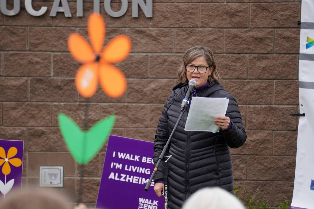 Promise flowers are held aloft during a ceremony ahead of the start of the Second Annual Kenai Peninsula Walk to End Alzheimers at the Challenger Learning Center of Alaska in Kenai, Alaska, on Saturday, Sept. 7, 2024. (Jake Dye/Peninsula Clarion)