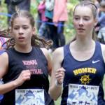 Kenai Centralճ Teresa Fallon and Homerճ Beatrix McDonough run side-by-side during the first lap of the girls varsity race in the George Plumley Invite on Saturday, Sept. 7, 2024, at Palmer High School in Palmer, Alaska. (Photo by Jeremiah Bartz/Frontiersman)