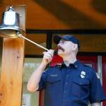 Mitch Miller, of the Kenai Fire Department, rings a bell in commemoration of the emergency services personnel who lost their lives in the Sept. 11, 2001, attacks during a commemoration ceremony at Kenai Fire Department in Kenai, Alaska, on Wednesday, Sept. 11, 2024. (Jake Dye/Peninsula Clarion)