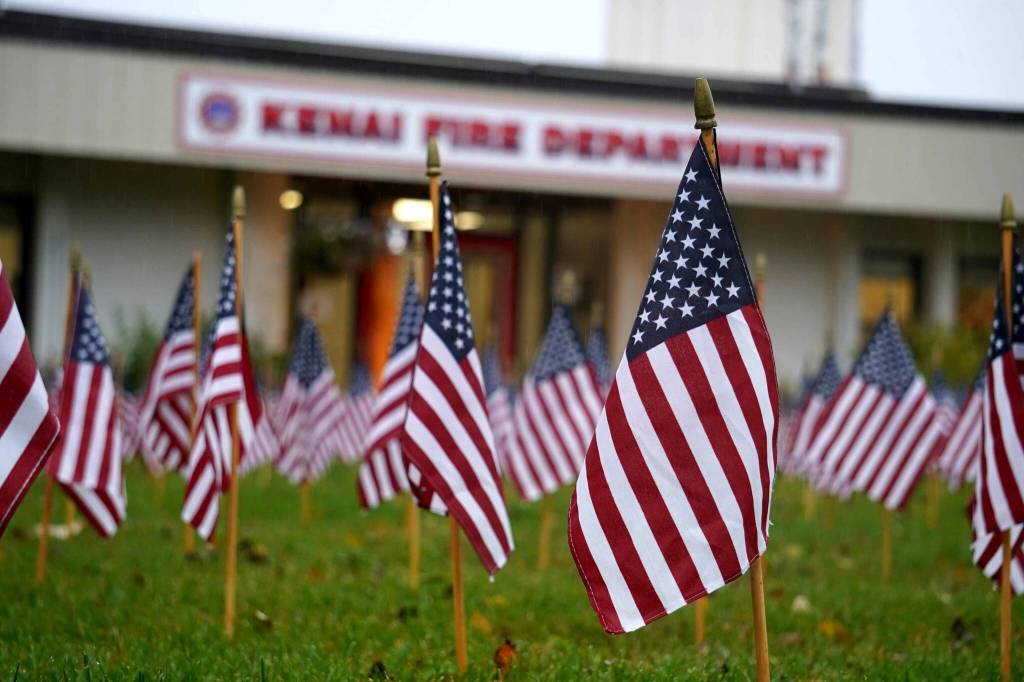 Flags placed in honor of the emergency services personnel who lost their lives in the Sept. 11, 2001, attacks fill the lawn in front of Kenai Fire Department during a commemoration ceremony in Kenai, Alaska, on Wednesday, Sept. 11, 2024. (Jake Dye/Peninsula Clarion)