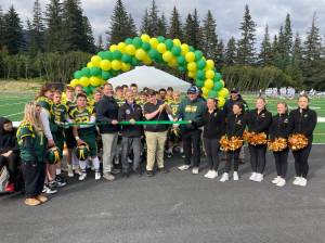 Center, from left: Kenai Peninsula Borough School District Superintendent Clayton Holland; Borough Mayor Peter Micciche; Seward High School Student Council President Otto Nipp; and Seward High School Principal Dr. Henry Burns participate in a ribbon-cutting ceremony for a new turf field at Roger Steinbrecher Memorial Field at Seward High School, Friday, Sept. 13, 2024, in Seward, Alaska. (Photo by Jeff Helminiak/Peninsula Clarion)