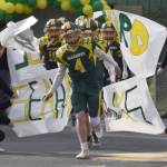 Seward quarterback Brett Gilmore leads his team onto the field Friday, Sept. 13, 2024, at Roger Steinbrecher Memorial Field in Seward, Alaska. (Photo by Jeff Helminiak/Peninsula Clarion)
