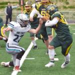 Sewards Noah Price runs against Nikiskis Ryder Maguire on Friday, Sept. 13, 2024, at Roger Steinbrecher Memorial Field in Seward, Alaska. (Photo by Jeff Helminiak/Peninsula Clarion)
