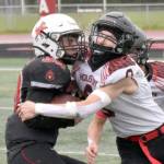 Kenai Centrals Cole Langham is tackled by Houstons Elias Johnson on Saturday, Sept. 14, 2024, at Ed Hollier Field at Kenai Central High School in Kenai, Alaska. (Photo by Jeff Helminiak/Peninsula Clarion)