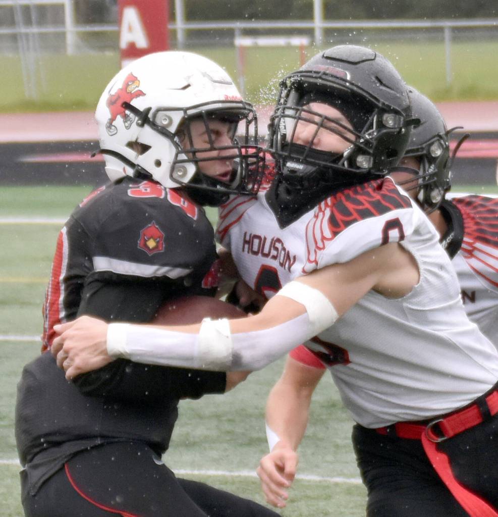 Kenai Centrals Cole Langham is tackled by Houstons Elias Johnson on Saturday, Sept. 14, 2024, at Ed Hollier Field at Kenai Central High School in Kenai, Alaska. (Photo by Jeff Helminiak/Peninsula Clarion)