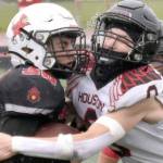 Kenai Central's Cole Langham is tackled by Houston's Elias Johnson on Saturday, Sept. 14, 2024, at Ed Hollier Field at Kenai Central High School in Kenai, Alaska. (Photo by Jeff Helminiak/Peninsula Clarion)