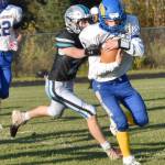 Monroe Catholic quarterback Ryan Mavencamp runs against Nikiskis Wyatt Maguire on Friday, Sept. 20, 2024, at Nikiski Middle-High School in Nikiski, Alaska. (Photo by Jeff Helminiak/Peninsula Clarion)