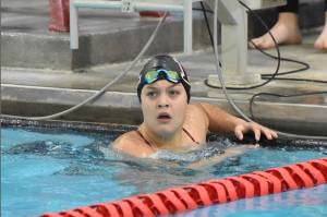 Kenai Central's Abigail Price finishes the anchor leg in the 400-yard freestyle relay at the Kenai Invitational on Saturday, Sept. 21, 2024, at Kenai Central High School in Kenai, Alaska. (Photo by Jeff Helminiak/Peninsula Clarion)