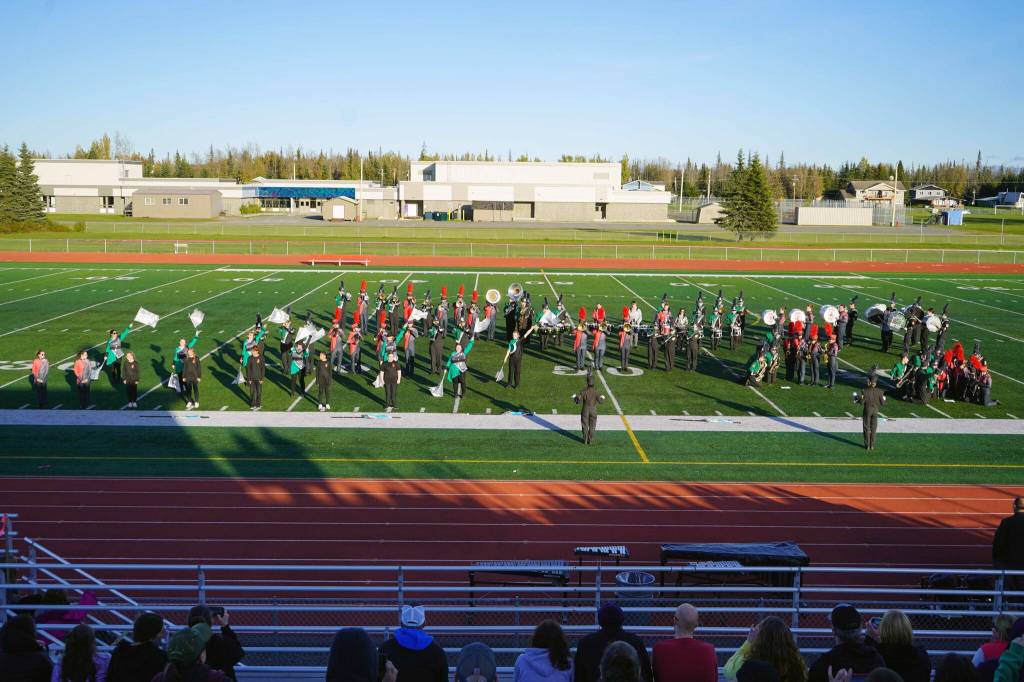 Colony High School marching band, Thee Northern Sound, Kenai Central High School Marching Band, and Soldotna High School Drumline together play Chappell Roans HOT TO GO! during the Kenai Marching Showcase at Ed Hollier Field in Kenai, Alaska, on Saturday, Sept. 21, 2024. (Jake Dye/Peninsula Clarion)