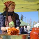 A presenter processes cabbage for storage at the fermentation station during the Harvest Moon Local Food Festival at Soldotna Creek Park in Soldotna, Alaska, on Saturday, Sept. 21, 2024. (Jake Dye/Peninsula Clarion)