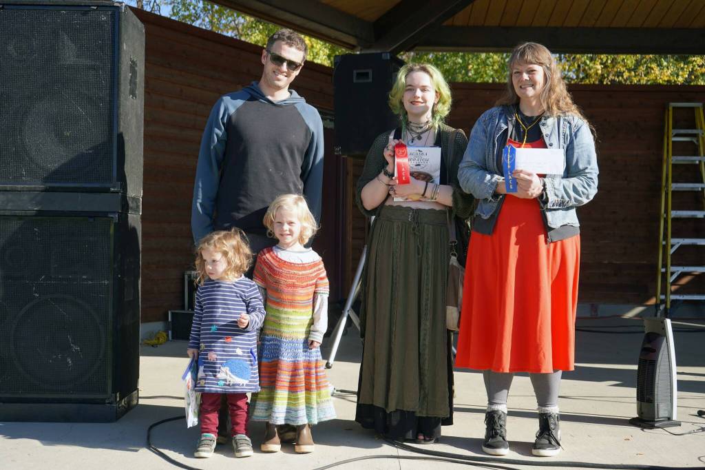 Adult winners of the Harvest Moon Local Food Festivals pie contest stand with their awards at Soldotna Creek Park in Soldotna, Alaska, on Saturday, Sept. 21, 2024. From left: third-place John, Helen and Matthew Messick; second-place Rachel Monson; and first-place Moira Ireland (Jake Dye/Peninsula Clarion)