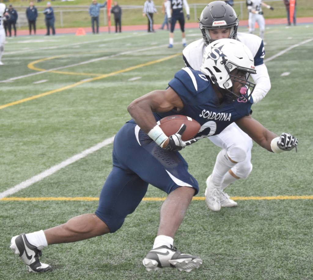 Soldotnas Andon Wolverton scores in front of Eagle Rivers Michael Roschi on Friday, Sept. 27, 2024, at Justin Maile Field at Soldotna High School in Soldotna, Alaska. (Photo by Jeff Helminiak/Peninsula Clarion)