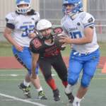 Kodiak quarterback Robert Anderson looks to throw under pressure from Kenai Centrals Roman Mosquito on Saturday, Sept. 28, 2024, at Ed Hollier Field at Kenai Central High School in Kenai, Alaska. (Photo by Jeff Helminiak/Peninsula Clarion)