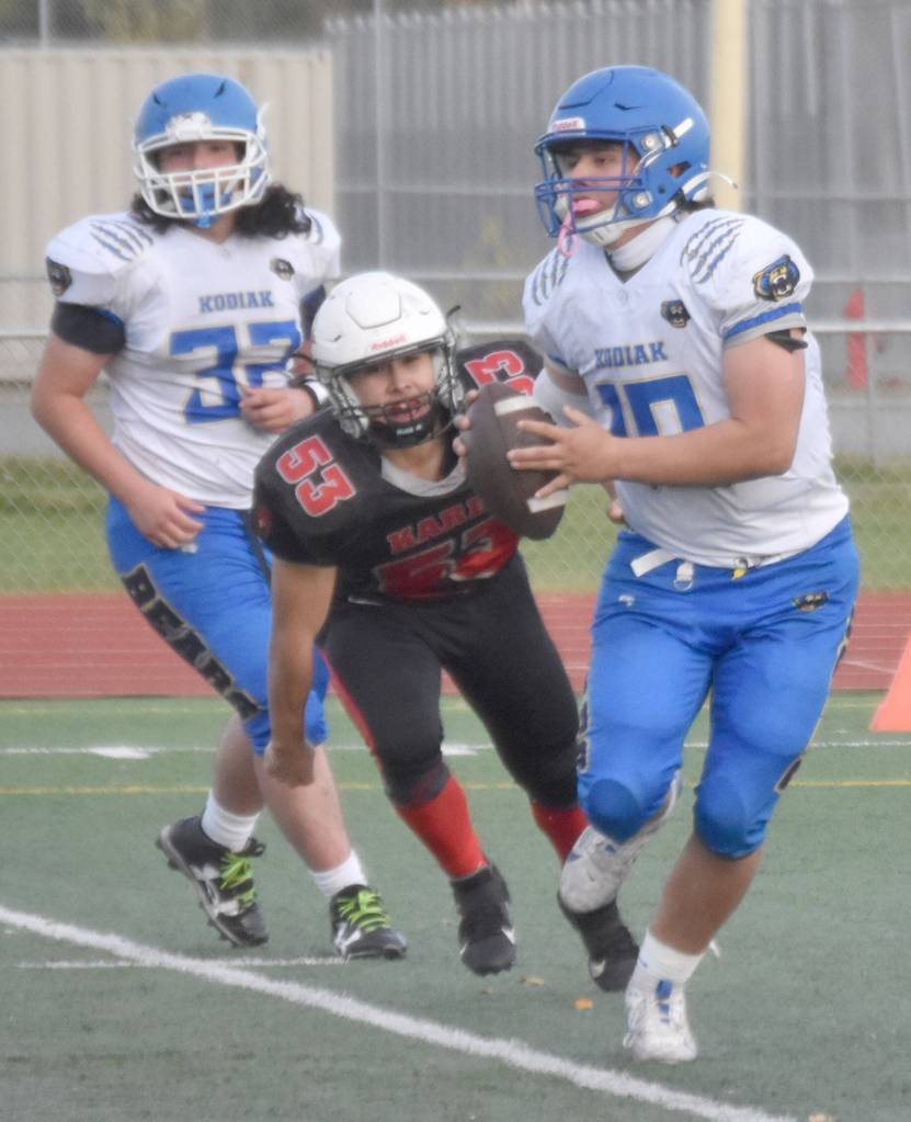 Kodiak quarterback Robert Anderson looks to throw under pressure from Kenai Centrals Roman Mosquito on Saturday, Sept. 28, 2024, at Ed Hollier Field at Kenai Central High School in Kenai, Alaska. (Photo by Jeff Helminiak/Peninsula Clarion)