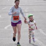Rachel Neuendorf and her daughter, Ember, finish off a relay victory for Relay 2024 at the Kenai River Marathon on Sunday, Sept. 29, 2024, in Kenai, Alaska. (Photo by Jeff Helminiak/Peninsula Clarion)