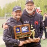 Kenai Central head coach Dan Verkuilen and assistant Brad Nyquist celebrate winning the Division II girls state soccer title Saturday, May 25, 2024, in Wasilla, Alaska. (Photo provided)