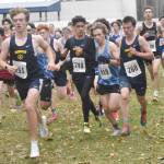 Homers Caleb Bunker leads the way as Valdezs Reggie Baksis races between Homers Jai Badajos and Reid Rauch in the Division II boys race at the state cross-country running meet on Saturday, Oct. 5, 2024, at Bartlett High School in Anchorage, Alaska. (Photo by Jeff Helminiak/Peninsula Clarion)