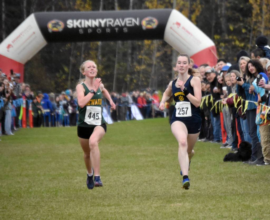 Sewards Juniper Ingalls and Homers Beatrix McDonough sprint to the finish in the Division II girls race at the state cross-country running meet on Saturday, Oct. 5, 2024, at Bartlett High School in Anchorage, Alaska. (Photo by Jeff Helminiak/Peninsula Clarion)