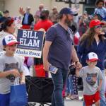 Bill Elam, candidate for the Alaska House of Representatives, walks with his family down the Kenai Spur Highway in Kenai, Alaska, during the Fourth of July Parade on Thursday, July 4, 2024. (Jake Dye/Peninsula Clarion)