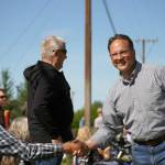 Rep. Ben Carpenter, R-Nikiski, shakes hands as he walks with the 67th Annual Soldotna Progress Days Parade on Marydale Avenue in Soldotna, Alaska, on Saturday, July 27, 2024. (Jake Dye/Peninsula Clarion)