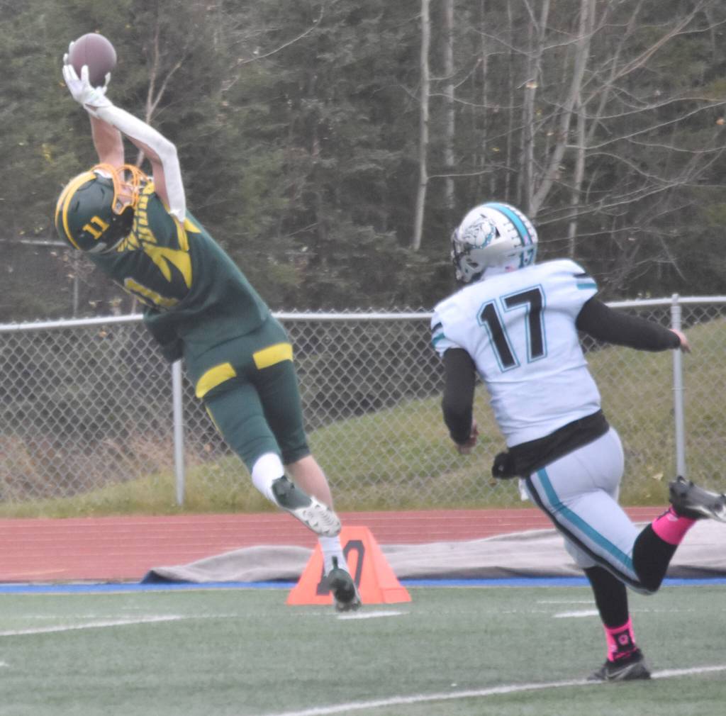 Sewards Hunter Forshee-Kurtz makes a catch for a first down over Nikiskis Ethan Ellis on Friday, Oct. 11, 2024, at Justin Maile Field in Soldotna, Alaska. (Photo by Jeff Helminiak/Peninsula Clarion)