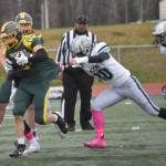 Sewards Ronan Bickling is dragged down by Nikiskis James Hemphill on Friday, Oct. 11, 2024, at Justin Maile Field in Soldotna, Alaska. (Photo by Jeff Helminiak/Peninsula Clarion)
