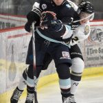Camden Shasby of the Anchorage Wolverines and Greye Rampton of the Kenai River Brown Bears fight for the puck Saturday, Oct. 12, 2024, at the Soldotna Regional Sports Complex in Soldotna, Alaska. (Photo by Jeff Helminiak/Peninsula Clarion)