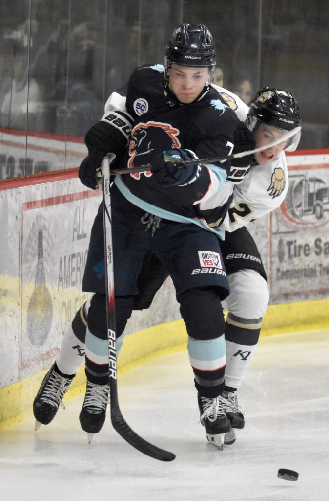 Camden Shasby of the Anchorage Wolverines and Greye Rampton of the Kenai River Brown Bears fight for the puck Saturday, Oct. 12, 2024, at the Soldotna Regional Sports Complex in Soldotna, Alaska. (Photo by Jeff Helminiak/Peninsula Clarion)