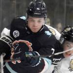Camden Shasby of the Anchorage Wolverines and Greye Rampton of the Kenai River Brown Bears fight for the puck Saturday, Oct. 12, 2024, at the Soldotna Regional Sports Complex in Soldotna, Alaska. (Photo by Jeff Helminiak/Peninsula Clarion)