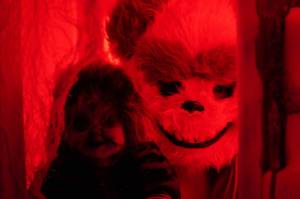 One frightening figure peers out from a doll house in the Haunted Chamber at the Kenai Chamber of Commerce and Visitor Center in Kenai, Alaska, on Friday, Oct. 18, 2024. (Jake Dye/Peninsula Clarion)