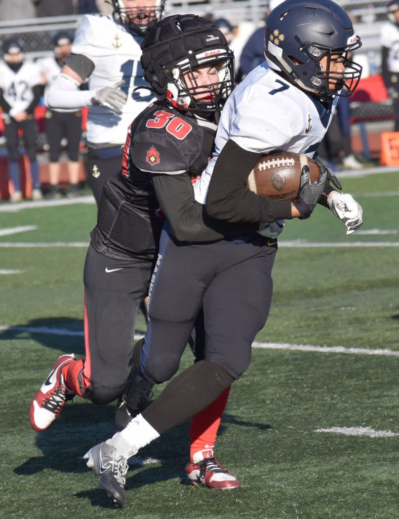 Kenai Centrals Cole Langham tackles Homers Joaquin Jackson on Saturday, Oct. 19, 2024, in the Division III First National Bowl at Veterans Memorial Field at Wasilla High School in Wasilla, Alaska. (Photo by Jeff Helminiak/Peninsula Clarion)