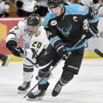 Cashen Naeve of the Wisconsin Windigo protects the puck from Dario Lass of the Kenai River Brown Bears on Friday, Oct. 18, 2024, at the Soldotna Regional Sports Complex in Soldotna, Alaska. (Photo by Jeff Helminiak/Peninsula Clarion)