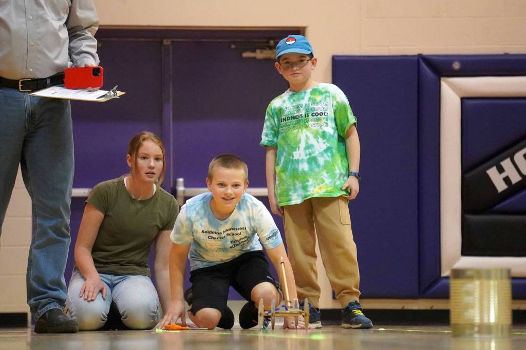 The Boys and oh wait theres Allison watch their machine roll across the gym floor during the Mind-A-Mazes competition at Skyview Middle School near Soldotna, Alaska, on Saturday, Oct. 19, 2024. (Jake Dye/Peninsula Clarion)
