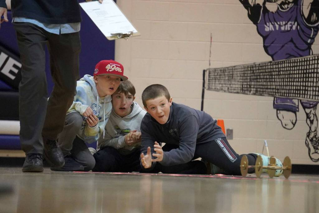 The CR7s watch their machine roll across the gym floor during the Mind-A-Mazes competition at Skyview Middle School near Soldotna, Alaska, on Saturday, Oct. 19, 2024. (Jake Dye/Peninsula Clarion)