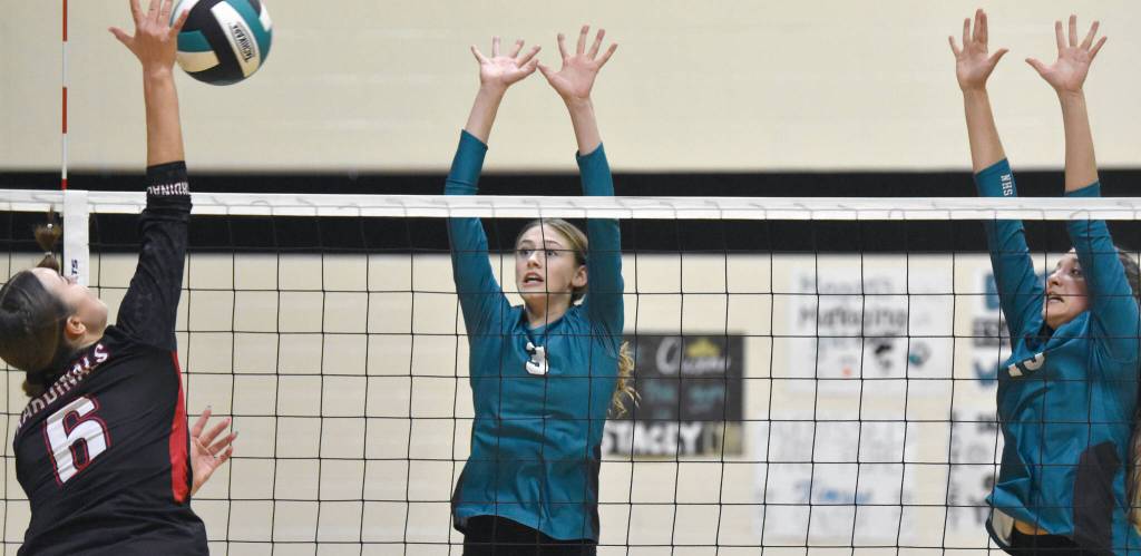 Kenai Centrals Stella Selanoff attacks against Nikiskis Blakeley Jorgensen and Mandee Roofe on Tuesday, Oct. 22, 2024, at Nikiski Middle-High School in Nikiski, Alaska. (Photo by Jeff Helminiak/Peninsula Clarion)