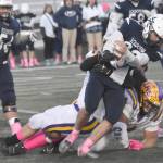 Soldotnas Wyatt Faircloth runs against Lathrops Luke Skinner and Zedekiah Fanene on Saturday, Oct. 26, 2024, at the First National Bowl Division II title game at Pride Field at Colony High School in Palmer, Alaska. (Photo by Jeff Helminiak/Peninsula Clarion)