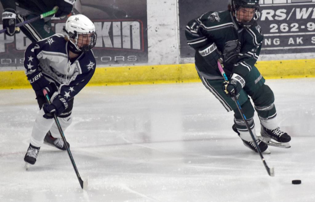 Colonys Jaxon Allen carries the puck against Soldotnas Draiden Mullican on Thursday, Oct. 31, 2024, at the Soldotna Regional Sports Complex in Soldotna, Alaska. (Photo by Jonas Oyoumick/For the Clarion)