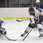 Kenai Centrals Logan Mese scores on Palmers Mily Christman during the Peninsula Ice Challenge on Thursday, Oct. 31, 2024, at the Kenai Multi-Purpose Facility in Kenai, Alaska. (Photo by Jeff Helminiak/Peninsula Clarion)