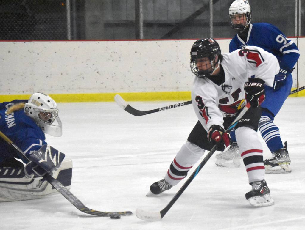 Kenai Centrals Logan Mese scores on Palmers Mily Christman during the Peninsula Ice Challenge on Thursday, Oct. 31, 2024, at the Kenai Multi-Purpose Facility in Kenai, Alaska. (Photo by Jeff Helminiak/Peninsula Clarion)