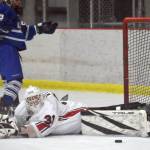Kenai Central goalie Evyn Witt makes a save on Palmers Kinan Greco during the Peninsula Ice Challenge on Thursday, Oct. 31, 2024, at the Kenai Multi-Purpose Facility in Kenai, Alaska. (Photo by Jeff Helminiak/Peninsula Clarion)