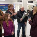 Rose Burke, center left, is celebrated for winning the U.S. Capitol Christmas Tree essay contest by U.S. Senator Lisa Murkowski, right, at the Kenai Municipal Airport in Kenai, Alaska, on Friday, Nov. 1, 2024. (Jake Dye/Peninsula Clarion)