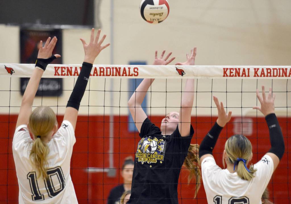 Kenai Central's Ellsi Miller attacks against Soldotna's Cassidy Kruse and Abygale Schaeffer on Friday, Nov. 1, 2024, at Kenai Central High School in Kenai, Alaska. (Photo by Jeff Helminiak/Peninsula Clarion)