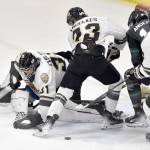 Kenai River Brown Bears goalie Leif Ekblad moves to cover the puck while teammates Brady Engelkes and Luke Hause try to keep Avery Anderson of the Minnesota Wilderness from scoring Saturday, Nov. 2, 2024, at the Soldotna Regional Sports Complex in Soldotna, Alaska. (Photo by Jeff Helminiak/Peninsula Clarion)